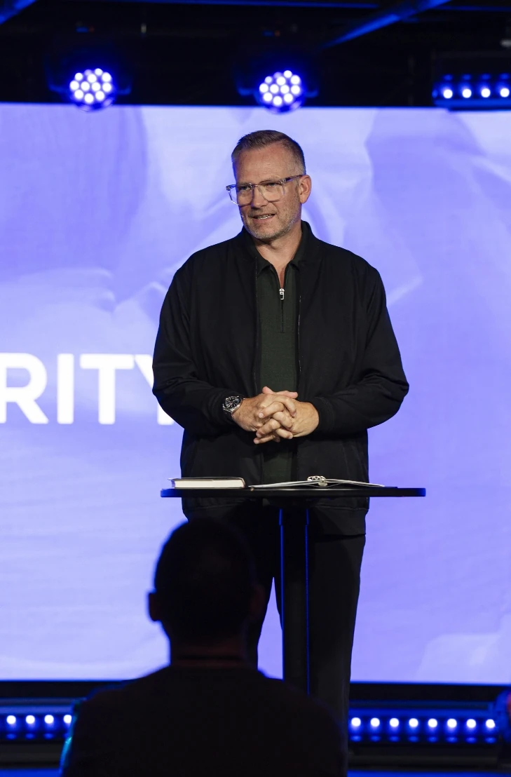 Mark Neal speaking on stage at a Clarity event