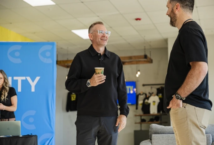 Mark Neal chatting with an attendee at a Clarity event