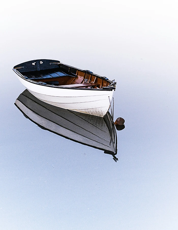 A small boat drifting on still water